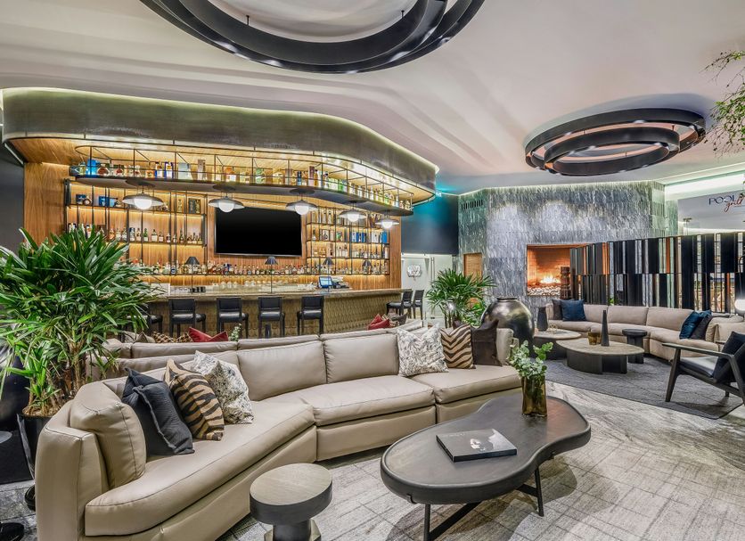 Grand Fiesta Americana Guadalajara Country Club lobby lounge with curved sectional seating and illuminated bar