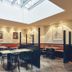art Hotel Tucholsky Bochum dining area with skylight, booth seating, and tables