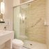 Quality Hotel Sao Caetano bathroom with glass walk-in shower, floating sink and toilet in São Caetano do Sul