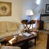 Vettonia in Ávila: hotel room with sofa, coffee table, armchair, lamps and bed