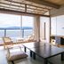 Hotel Biwanso in Nanao: tatami room with sea view, low table, and chairs on balcony
