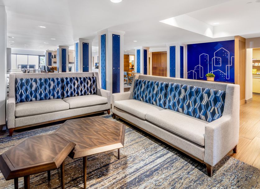 Holiday Inn Express & Suites Colorado Springs-First & Main lobby seating area with sofas and coffee tables