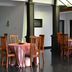 Grand Crown Hotel in Anuradhapura dining area with wooden chairs and tables on a glossy floor