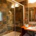 Hotel-Apartamento Rural Atxurra in Bermeo bathroom with glass shower, tiled walls and vanity sink