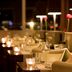 Van Der Valk Hotel Ara in Zwijndrecht restaurant with candlelit tables and pink flowers