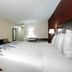 Red Roof Inn Hillsville guest room with king bed, wall-mounted TV, desk and lamp