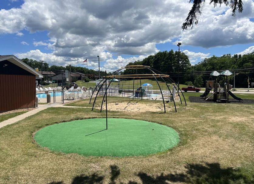 All Star Inn & Suites in Wisconsin Dells: outdoor playground and pool area under a cloudy sky