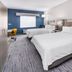 Holiday Inn Express & Suites Colorado Springs-First & Main By IHG room with two beds and blue accent wall