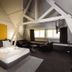 Hotel Orion Ghent room with king bed, seating area, and exposed white beams