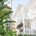 El Mosquito Boutique Hotel Playa Bonita in Las Terrenas, white balconies amid lush tropical greenery