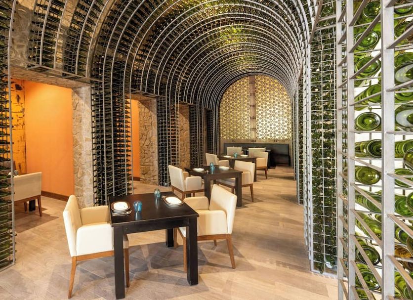 Royalton Riviera Cancun lounge with arched lattice ceiling, tables and chairs in Puerto Morelos