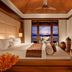 Gaya Island Resort room with king bed, wood ceiling, and balcony ocean view in Kota Kinabalu