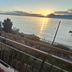 Hotel Garden in Torri Del Benaco balcony with chairs overlooking lake sunset and sailboat