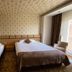 Sor Hotel Eskisehir room in Eskişehir with one double bed, one single bed, and balcony door