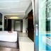 Chalay Monta Hua Hin guest room with king bed and balcony view toward a bright outdoor pool