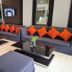 Crystal Suites Suvarnabhumi Airport lobby seating area with gray sofas and orange pillows in Bangkok