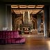 Grand Bohemian Lodge Greenville lobby with magenta seating, fireplace, and dramatic chandelier