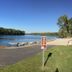 The Connecticut River Valley Inn in Glastonbury with riverfront dock, sandy beach and clear blue sky.