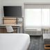 TownePlace Suites by Marriott Pigeon Forge guest room with sofa, desk, TV and window view