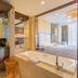 Beijing Rishengchang Hotel in Beijing bathroom with soaking tub beside a bedroom and vanity