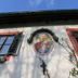 Haus Wartenberg in Salzburg facade with Madonna mural, green shutters, and window details