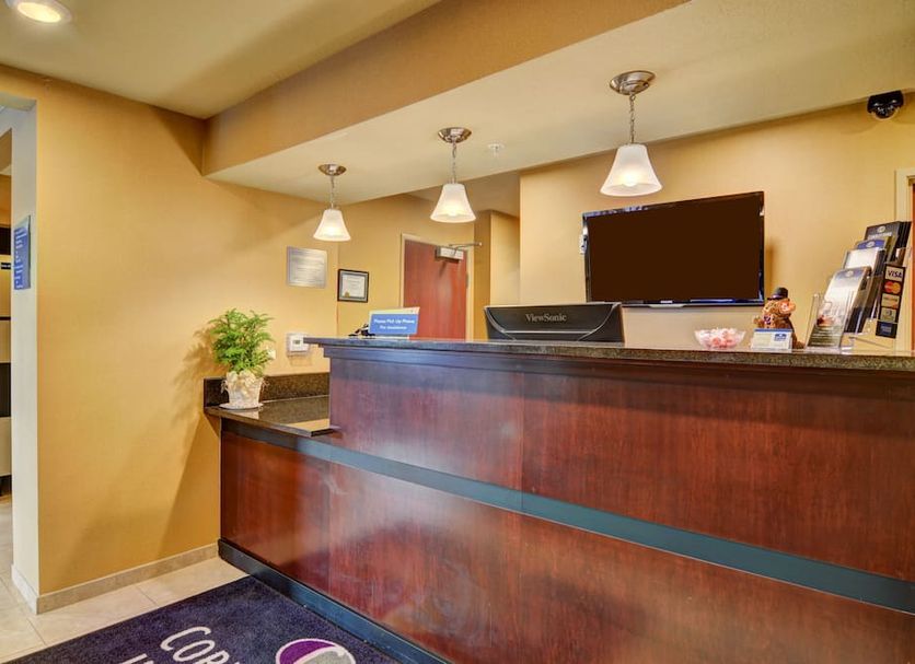 The Inn at Punxsutawney front desk reception area with wood counter and hanging pendant lights in Punxsutawney