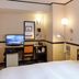 Toyoko Inn Gumma Isesaki Ekimae room with TV, desk, chair and floor lamp in Isesaki