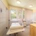 Treatment room at Hungarospa Thermal Hotel in Hajdúszoboszló with massage tables and tiled walls