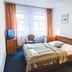 Hotel u České Koruny in Hradec Králové: guest room with double bed, TV, chairs and window