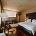 Hotel da Oliveira in Guimarães guest room with king bed, desk, lamp, and dark wood floors