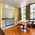 Capital O Hotel Suites Marne, Mexico City room with kitchenette, dining table, and large window