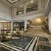 NH Madrid Nacional in Madrid lobby with marble floors, seating area, and grand staircase