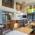 Hampton by Hilton San Jose Airport in Alajuela lobby lounge with bar seating and dining tables