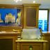 Stadthotel Augsburg reception desk with framed city artwork and bright lobby lighting