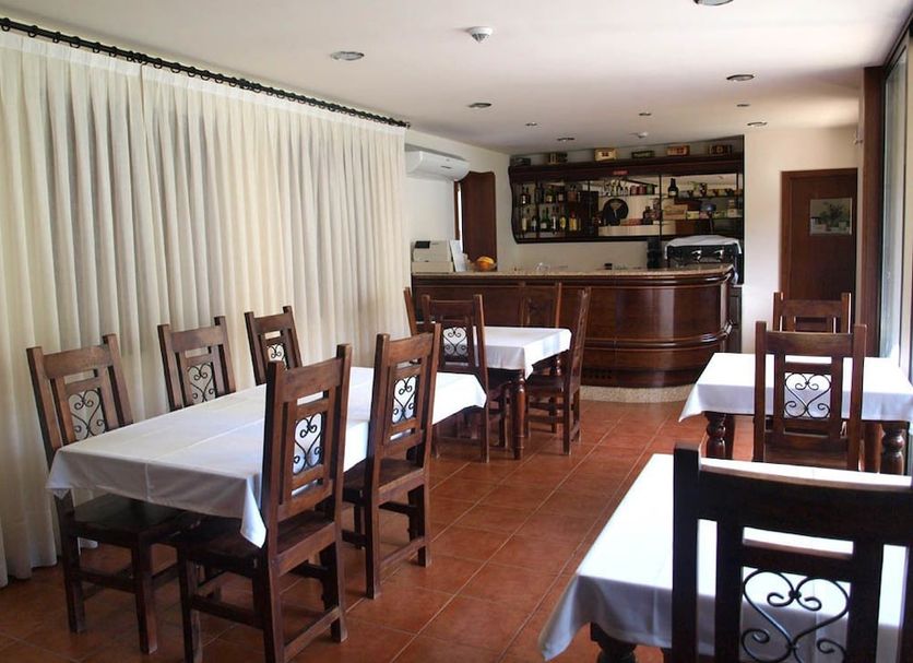 Hotel Casa do Tua in Foz Tua restaurant with wooden tables, chairs, and a bar area
