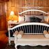 Chalet of Canandaigua, Canandaigua: cozy wood-paneled bedroom with white bed and chaise lounge