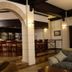 Apollo Hotel Johannesburg bar area with arched doorway, high stools and seating
