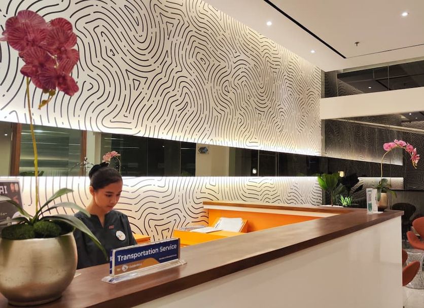 Zuri Express Lippo Cikarang lobby reception desk with patterned wall art in Bekasi