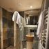 Hôtel-Spa Le Saint Cirq spa bathroom in Bouzies with tiled shower, stone sink, mirror and heated towel rack