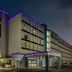 Baymont by Wyndham Laredo exterior at dusk with purple-lit entrance and multi-story facade