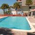Gulf Towers Resort Motel in Indian Rocks Beach with an outdoor pool, palm trees, and loungers