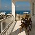 Margie Mykonos Hotel balcony with sea view, lounge chairs, and cruise ships in Mykonos