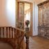 Olea Leya Hotel in Ayvalik: rustic wooden staircase and vintage cabinet in a bright hallway