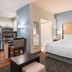 Homewood Suites by Hilton Bonita Springs Naples North guest room with king bed and kitchenette in Bonita Springs