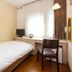 Fukuyama Terminal Hotel guest room with single bed, desk, chair, TV and window in Fukuyama