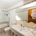 allsun Hotel Paguera Vera Beach bathroom with bathtub, sink, toilet and large mirror in Peguera