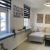Altstadt-Hotel Gosequell in Goslar: bright guest room with sofa, coffee table, windows, and wall art