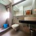 Park Palace Hotel Kolkata bathroom with walk-in shower, wall-mounted toilet and vessel sink
