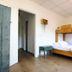 Arena Surf Hotel, Somo: simple room with wooden bunk bed, white bedding, and a small stool on wood flooring
