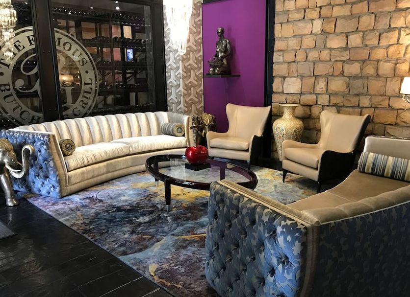 Cape Town Lodge Hotel lobby seating area with velvet sofas, glass coffee table and exposed brick wall in Cape Town